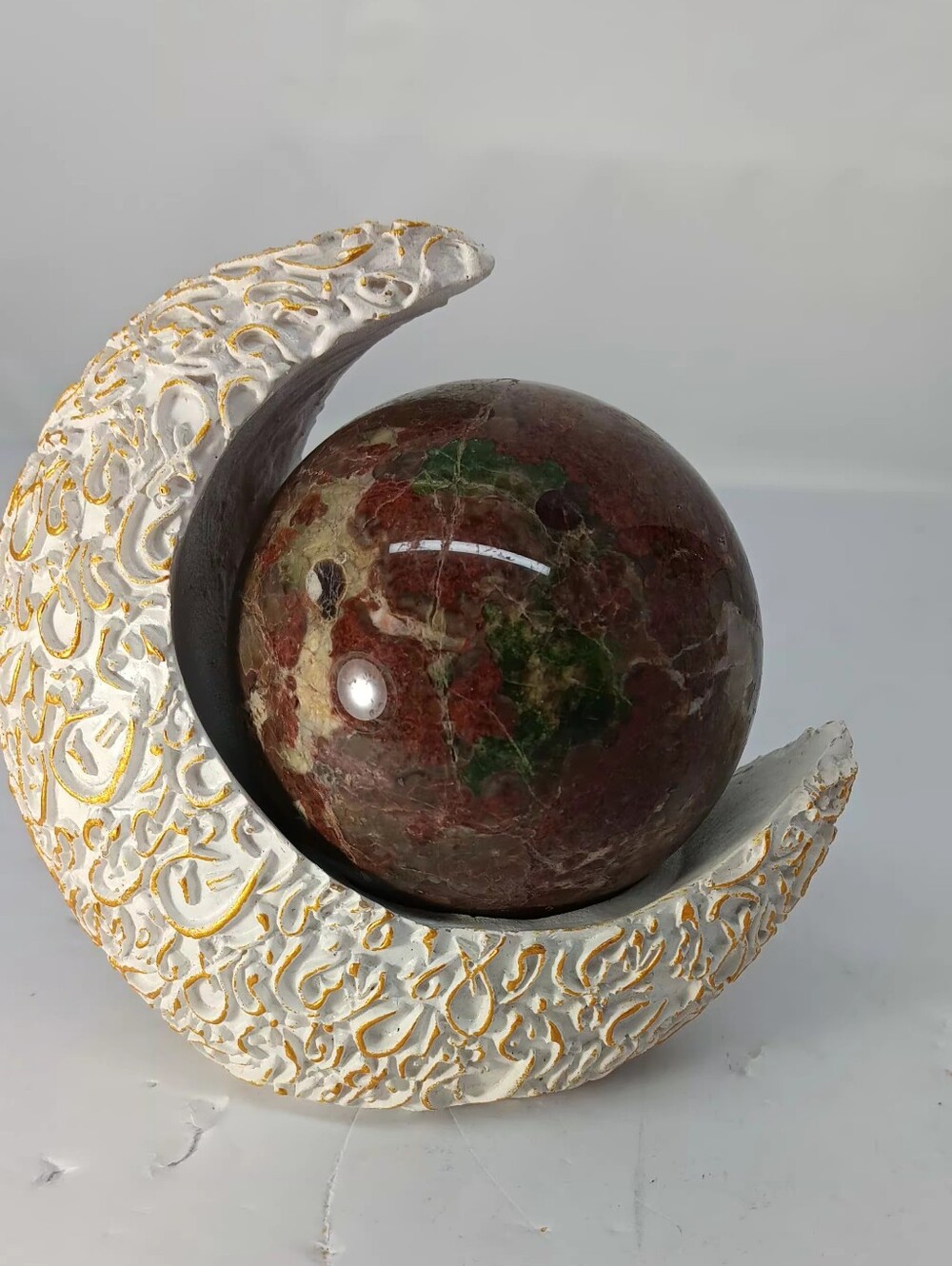 Dragons Blood Jasper Crystal Sphere On White And Gold Cresent Moon Holder